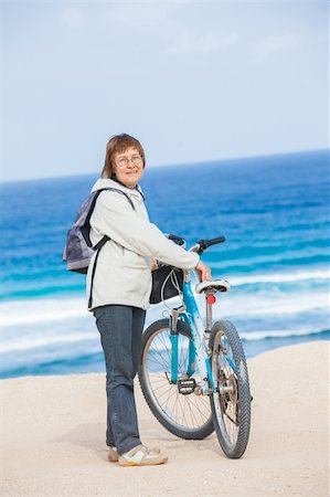 seniors bike riding on beach - A nice senior lady riding a bike on the beach. Lanzarote. Canaries Stock Photo - Budget Royalty-Free & Subscription, Code: 400-05905924