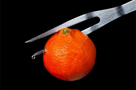 tangerine on a plug on a black background Stock Photo - Budget Royalty-Free & Subscription, Code: 400-05906047