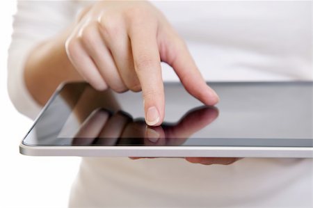 simsearch:400-04907291,k - Hand of a woman using a digital tablet on white Fotografie stock - Microstock e Abbonamento, Codice: 400-05906088