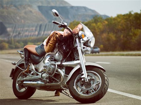 Girl on a motorcycle on the road in an outdoor Stock Photo - Budget Royalty-Free & Subscription, Code: 400-05906614