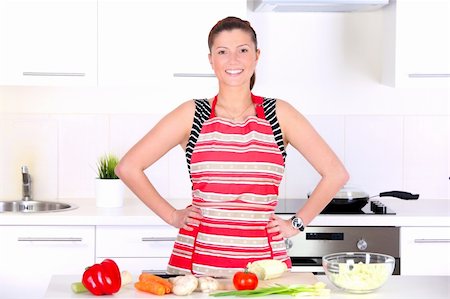 A portrait of a young beautiful wife working in a modern kitchen Stock Photo - Budget Royalty-Free & Subscription, Code: 400-05906706