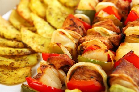 shashlik - A close-up of fresh Polish chicken shashlick with baked potatoes on a white plate Stock Photo - Budget Royalty-Free & Subscription, Code: 400-05906707