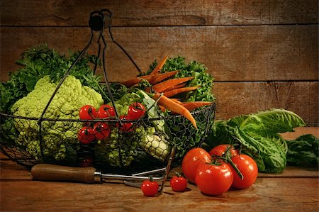 Freshly picked vegetables in basket on wooden table Stock Photo - Budget Royalty-Free & Subscription, Code: 400-05907127