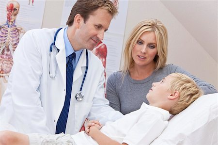 A male doctor examining a sick boy child with his mother at a hospital clinic or surgery Stock Photo - Budget Royalty-Free & Subscription, Code: 400-05907936