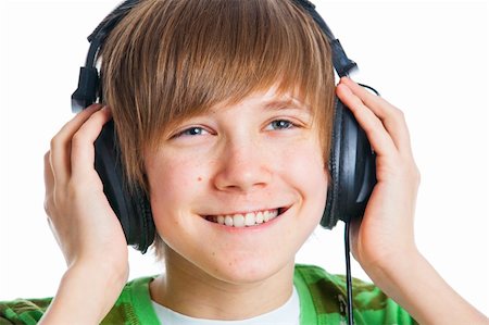 Close-up portrait of a male teenager listening to music with headphone. Isolated on white. Photographie de stock - Aubaine LD & Abonnement, Code: 400-05908068