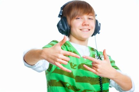 Close-up portrait of a male teenager listening to music with headphone. Isolated on white. Focus on the hands Stock Photo - Budget Royalty-Free & Subscription, Code: 400-05908099