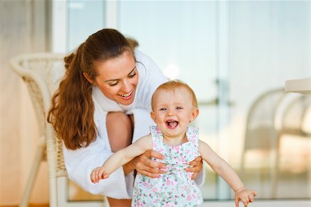 simsearch:400-06086432,k - Young mother in bathrobe playing with baby on terrace Stockbilder - Microstock & Abonnement, Bildnummer: 400-05908555