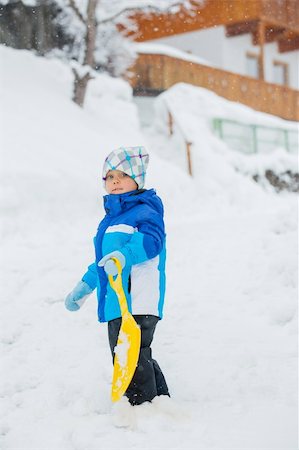 simsearch:400-05909257,k - Cute little boy in blue riding on a sled near  the Austrian cottage Photographie de stock - Aubaine LD & Abonnement, Code: 400-05909255