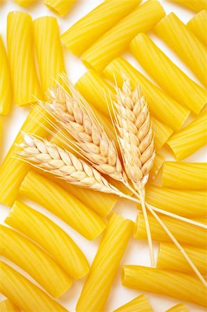 Pasta with wheat ears as background Foto de stock - Royalty-Free Super Valor e Assinatura, Número: 400-05909270