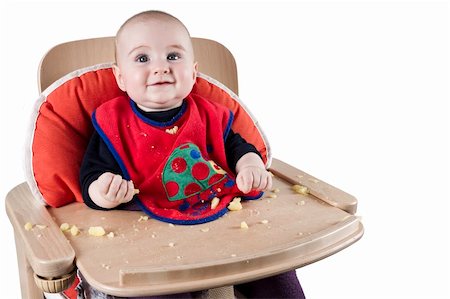 toddler eating potatoes in highchair Foto de stock - Royalty-Free Super Valor e Assinatura, Número: 400-05909847
