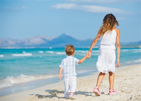 Back view of young beautiful girl and her brather walking at pretty beach. Majorca, Spaine Stock Photo - Budget Royalty-Free & Subscription, Code: 400-05909887