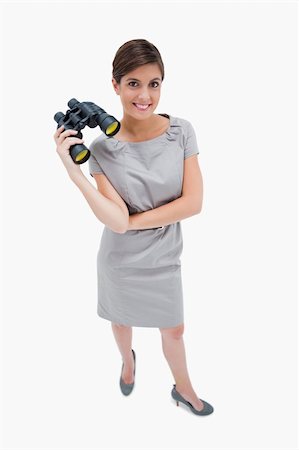 simsearch:400-04554899,k - Woman standing with binoculars against a white background Stock Photo - Budget Royalty-Free & Subscription, Code: 400-05900204