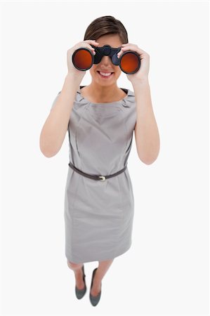 simsearch:400-04554899,k - Woman using binoculars against a white background Stock Photo - Budget Royalty-Free & Subscription, Code: 400-05900202