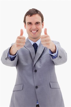 simsearch:400-04129711,k - Smiling businessman giving thumbs up against a white background Stock Photo - Budget Royalty-Free & Subscription, Code: 400-05900224