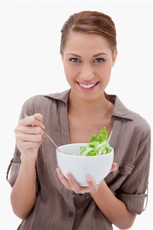 simsearch:400-05751129,k - Woman with bowl of salad against a white background Stockbilder - Microstock & Abonnement, Bildnummer: 400-05900333