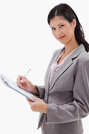 simsearch:400-06633122,k - Side view of businesswoman taking notes against a white background Stock Photo - Budget Royalty-Free & Subscription, Code: 400-05900410
