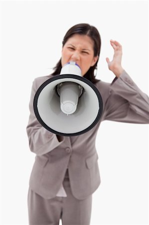 simsearch:400-06763387,k - Angry businesswoman shouting through businesswoman against a white background Stock Photo - Budget Royalty-Free & Subscription, Code: 400-05900443