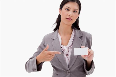 simsearch:400-05368656,k - Businesswoman pointing at name badge against a white background Stockbilder - Microstock & Abonnement, Bildnummer: 400-05900451