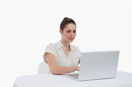 simsearch:400-05729276,k - Businesswoman using a laptop against a white background Stock Photo - Budget Royalty-Free & Subscription, Code: 400-05900557