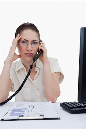 phone with pain - Portrait of a tired manager making a phone call while looking at statistics against a white background Stock Photo - Budget Royalty-Free & Subscription, Code: 400-05900637