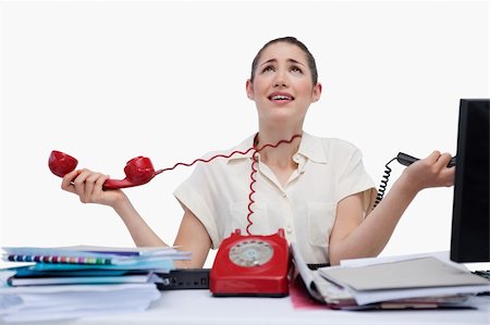 simsearch:400-05710310,k - Stressed secretary answering the phones against a white background Stock Photo - Budget Royalty-Free & Subscription, Code: 400-05900645