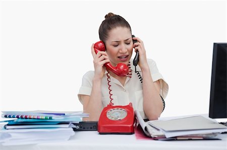 simsearch:400-05710310,k - Stressed young secretary answering the phones against a white background Stock Photo - Budget Royalty-Free & Subscription, Code: 400-05900646