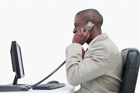 Side view of an angry businessman making a phone call against a white background Stock Photo - Budget Royalty-Free & Subscription, Code: 400-05900682