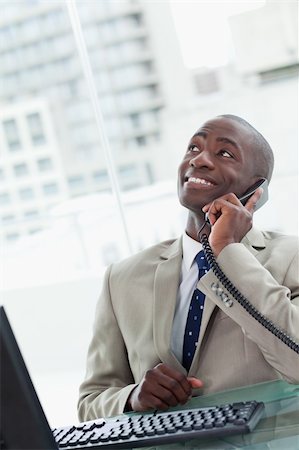 simsearch:400-05900712,k - Portrait of an office worker on the phone looking away from the camera Stock Photo - Budget Royalty-Free & Subscription, Code: 400-05900712