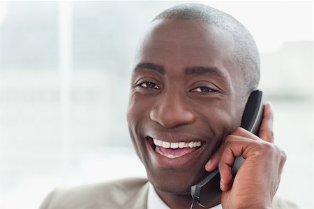 simsearch:400-05900712,k - Close up of a cheerful businessman on the phone in his office Stock Photo - Budget Royalty-Free & Subscription, Code: 400-05900733