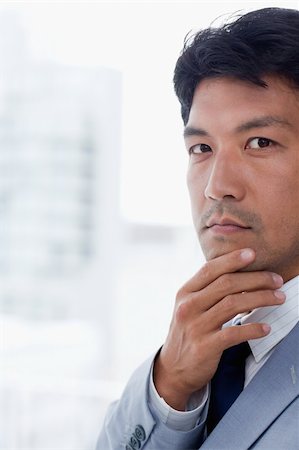 simsearch:400-04631810,k - Portrait of a handsome office worker thinking while looking at the camera Stock Photo - Budget Royalty-Free & Subscription, Code: 400-05900763