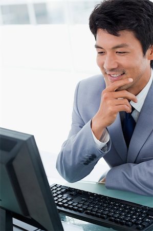simsearch:400-05285550,k - Portrait of a smiling manager using a computer in his office Stockbilder - Microstock & Abonnement, Bildnummer: 400-05900775