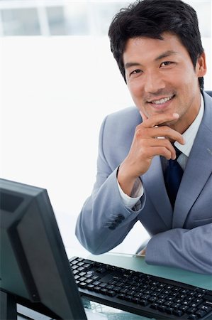 simsearch:400-05900712,k - Portrait of a happy manager using a computer in his office Stock Photo - Budget Royalty-Free & Subscription, Code: 400-05900777