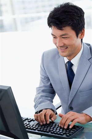 simsearch:400-04879813,k - Portrait of a manager using a computer in his office Stock Photo - Budget Royalty-Free & Subscription, Code: 400-05900779