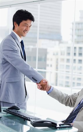 Portrait of an employee shaking the hand of his manager in an office Stock Photo - Budget Royalty-Free & Subscription, Code: 400-05900787