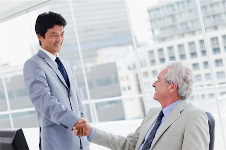 Employee shaking the hand of his manager in an office Stock Photo - Budget Royalty-Free & Subscription, Code: 400-05900789