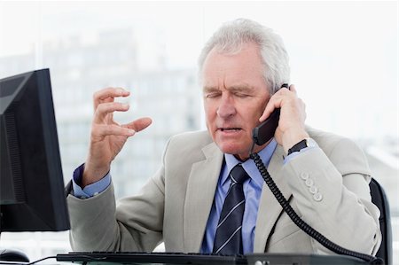simsearch:400-08649785,k - Irritated senior manager on the phone in his office Stock Photo - Budget Royalty-Free & Subscription, Code: 400-05900808