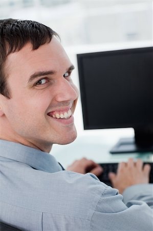 executives on table back - Back view of a young businessman using a monitor in his office Stock Photo - Budget Royalty-Free & Subscription, Code: 400-05900846