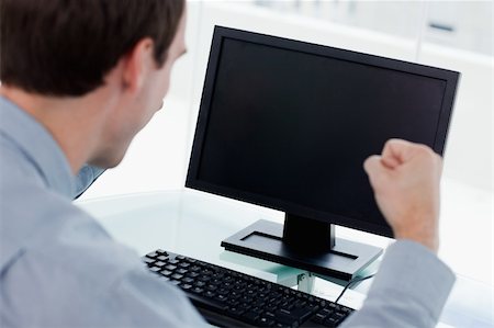 simsearch:400-05900712,k - Back view of a businessman working with a computer with the fists up in his office Stock Photo - Budget Royalty-Free & Subscription, Code: 400-05900848