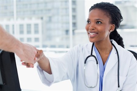 face of doctor and nurse - Female doctor shaking a hand in her office Stock Photo - Budget Royalty-Free & Subscription, Code: 400-05900841