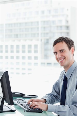 simsearch:400-08649785,k - Side view of a happy office worker using a monitor in his office Stock Photo - Budget Royalty-Free & Subscription, Code: 400-05900876