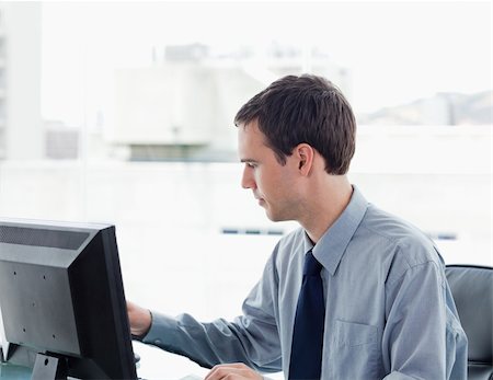 simsearch:400-03996768,k - Serious office worker using a monitor in his office Stock Photo - Budget Royalty-Free & Subscription, Code: 400-05900878