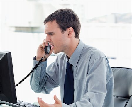 simsearch:400-08649785,k - Irritated office worker on the phone in his office Stock Photo - Budget Royalty-Free & Subscription, Code: 400-05900879