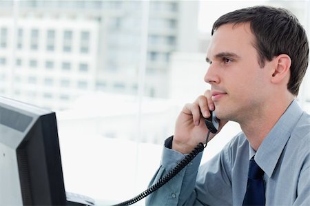 simsearch:400-06393704,k - Young office worker on the phone`in his office Stockbilder - Microstock & Abonnement, Bildnummer: 400-05900880