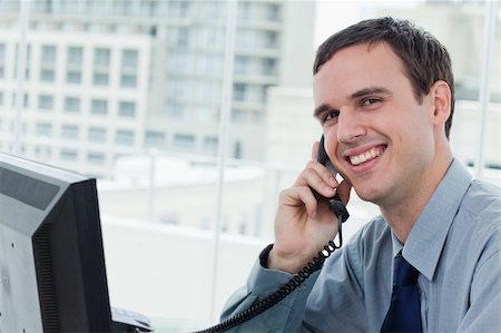 simsearch:400-06393704,k - Happy office worker on the phone in his office Stockbilder - Microstock & Abonnement, Bildnummer: 400-05900882