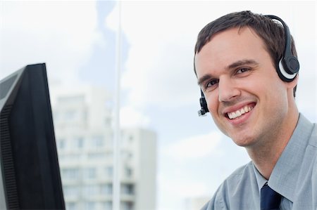 Happy office worker using a headset his office Stock Photo - Budget Royalty-Free & Subscription, Code: 400-05900891
