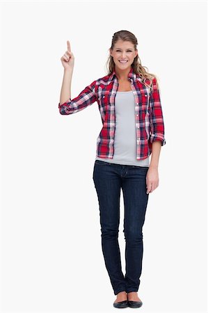 simsearch:400-05895521,k - Portrait of a woman pointing at a copy space against a white background Stock Photo - Budget Royalty-Free & Subscription, Code: 400-05900920