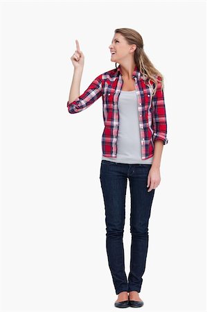 finger pointing up - Portrait of a smiling woman pointing at a copy space against a white background Stock Photo - Budget Royalty-Free & Subscription, Code: 400-05900922