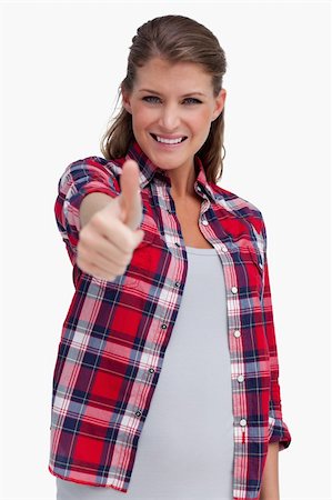 simsearch:400-06769983,k - Portrait of a blissful woman with the thumb up against a white background Foto de stock - Royalty-Free Super Valor e Assinatura, Número: 400-05900940