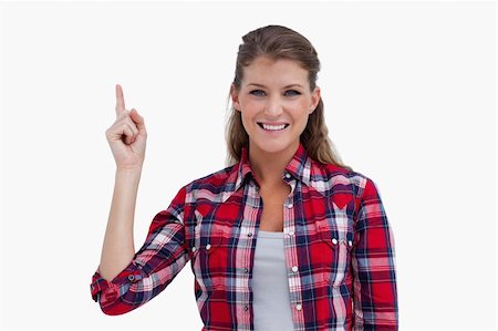 simsearch:400-05895521,k - Woman pointing at a copy space against a white background Stock Photo - Budget Royalty-Free & Subscription, Code: 400-05900950