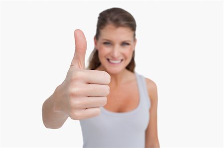 simsearch:400-06769983,k - Smiling woman with the thumb up with the camera focus on her hand Foto de stock - Royalty-Free Super Valor e Assinatura, Número: 400-05900991